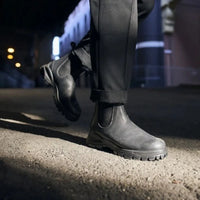 Man in black dress paints wearing black Blundstone lug sole boots 