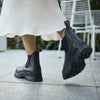 Girl in a white dress wearing black Blundstone lug sole boots 
